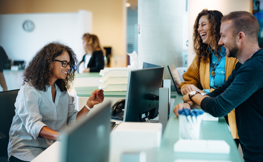 Local government employee helping laughing community members